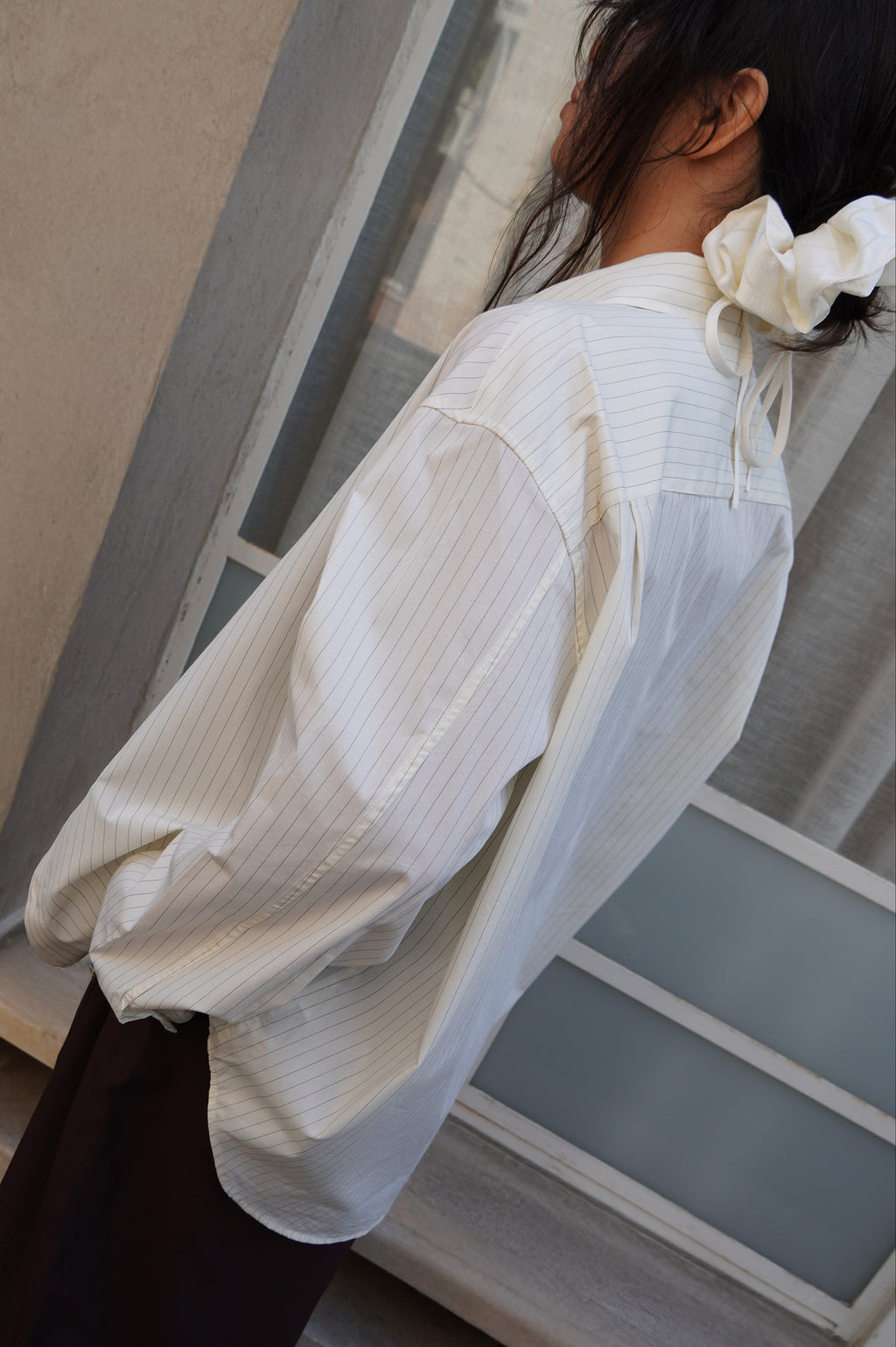 Model wearing a white pinstriped shirt