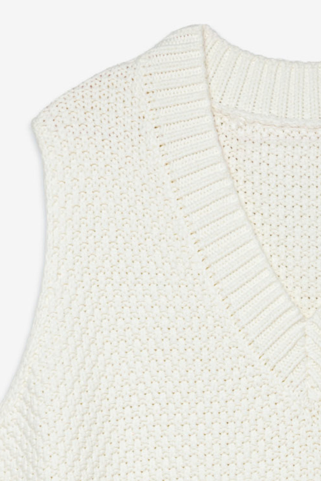 Close-up of a white knitted vest