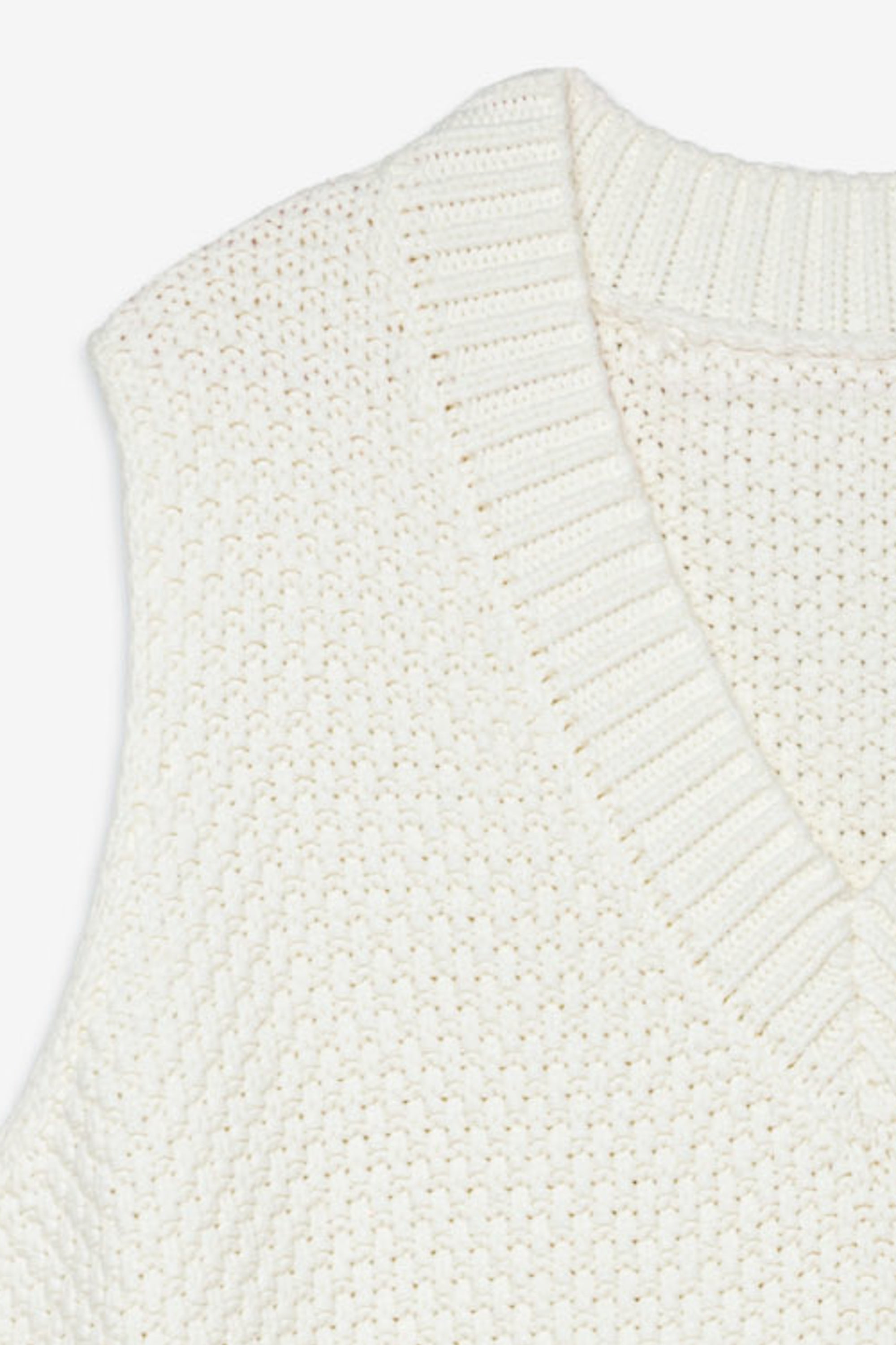 Close-up of a white knitted vest