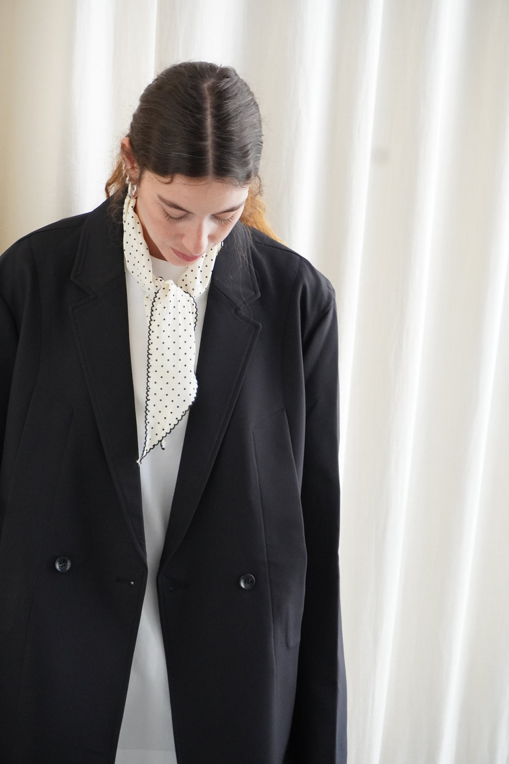 Model wearing a black blazer and white oversize T shirt