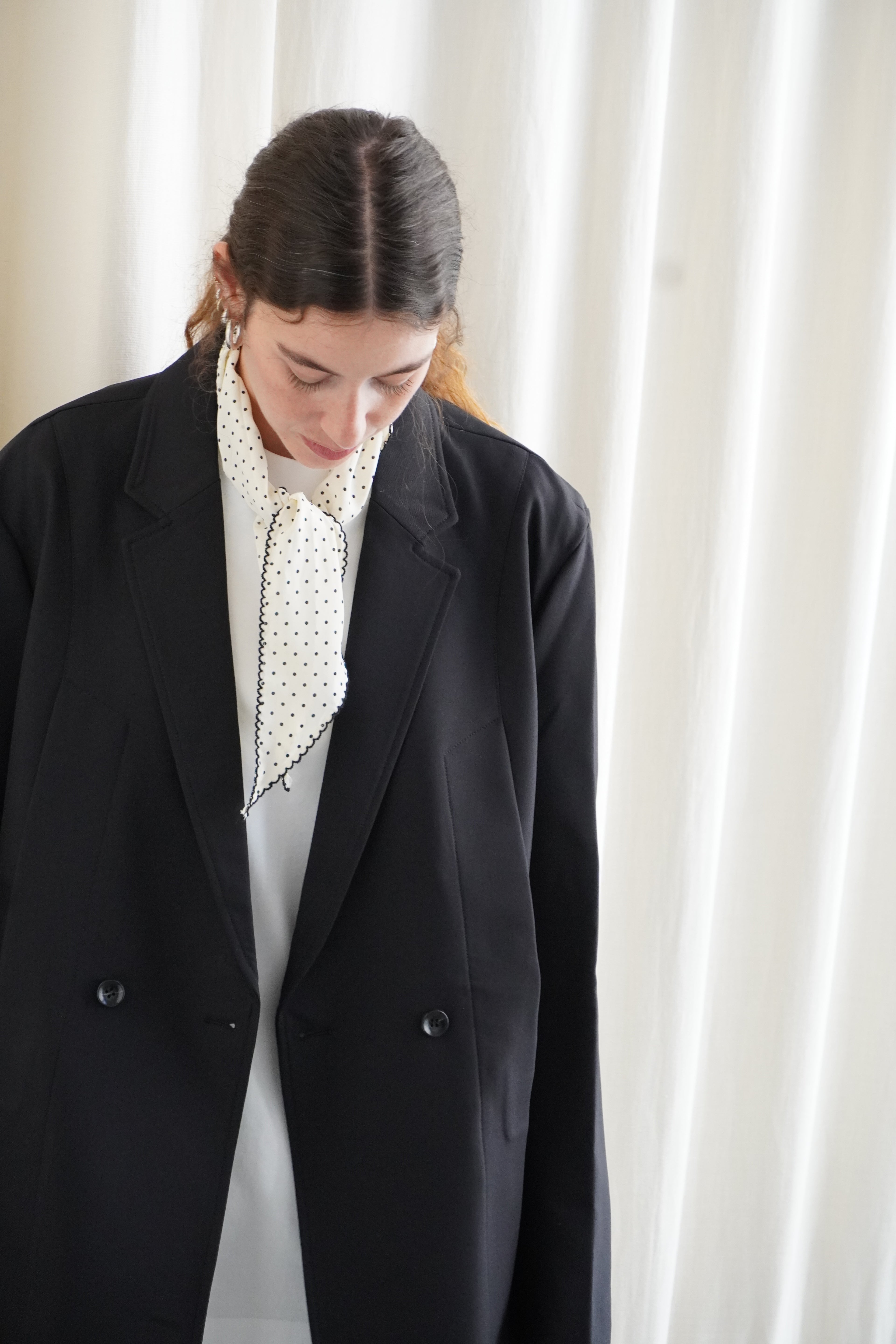 Model wearing a black blazer and white oversize T shirt